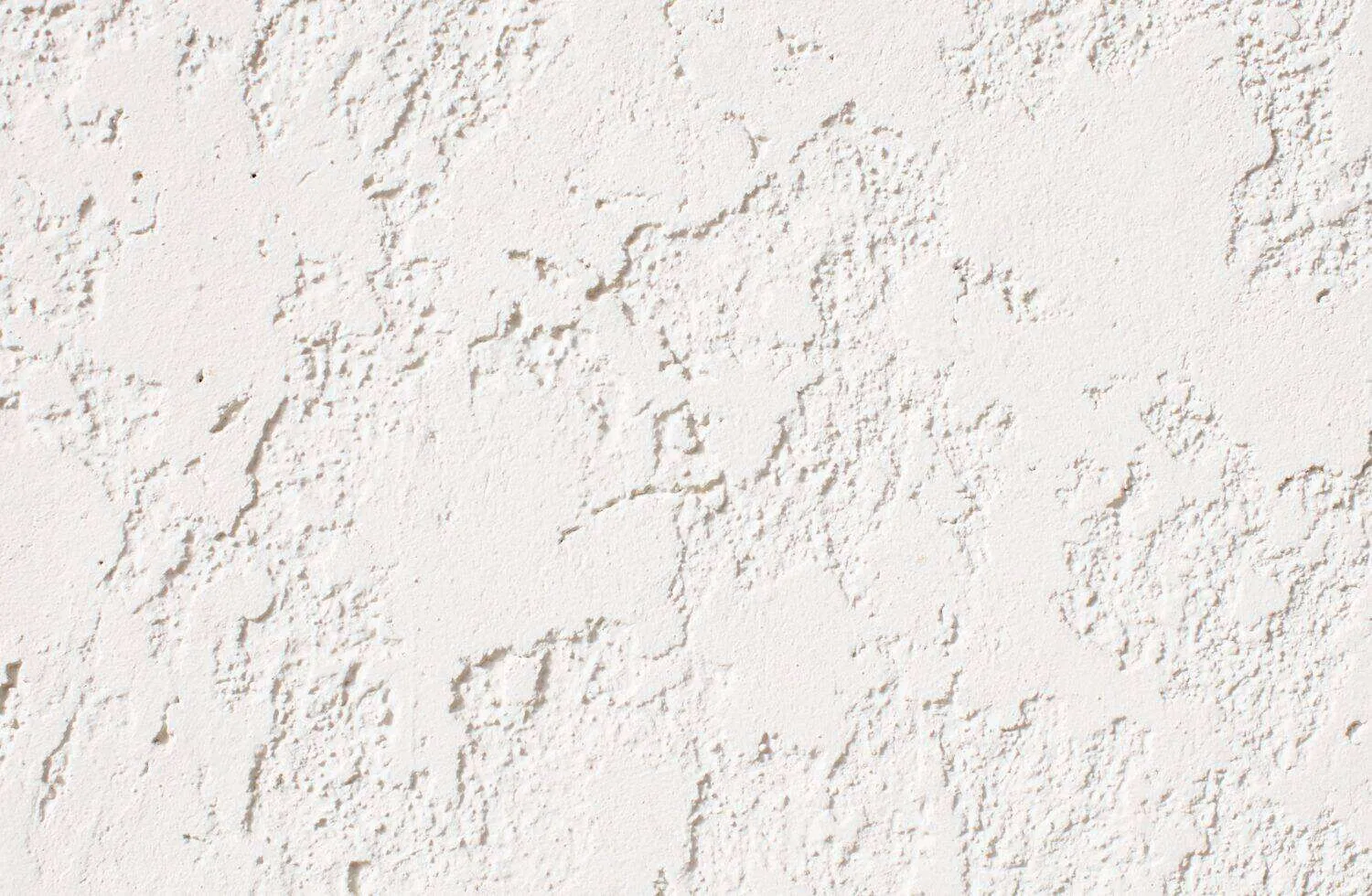 Close-up view of a white stucco wall with a rough, dash finish texture. — Pinole area