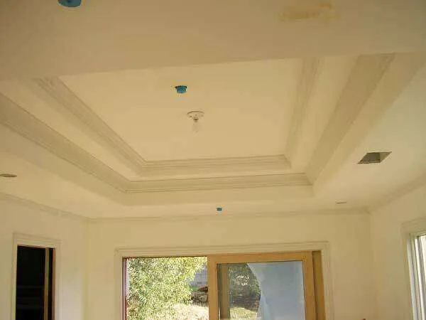 Interior room with coffered ceiling and recessed lighting, large window with wooden frame. — Sausalito area