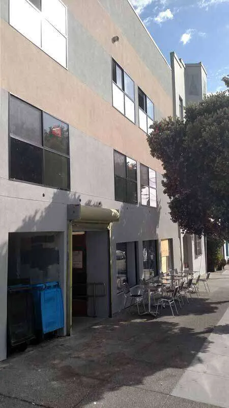 Three-story commercial building with stucco facade and large windows in San Francisco. — work near Larkspur