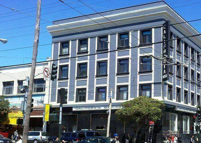 Multi-story commercial building with stucco exterior and decorative trim in San Rafael.