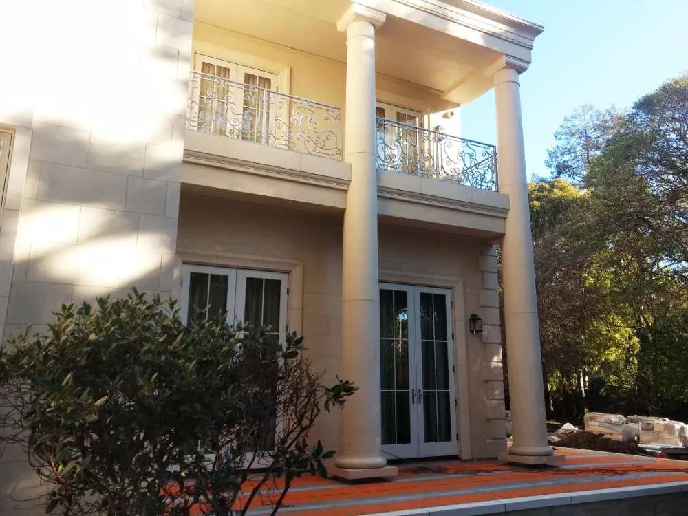 Two-story residential building with large columns and decorative railings in Hillsborough.