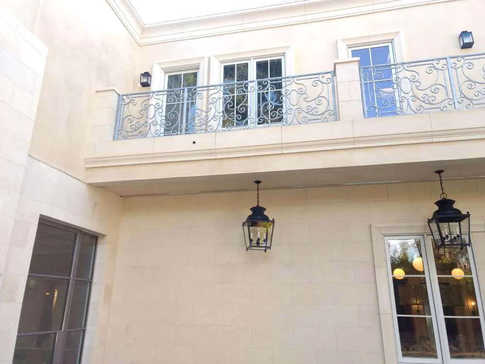 Exterior view of a residence with a balcony, metal railing, and hanging lanterns. — Hillsborough area