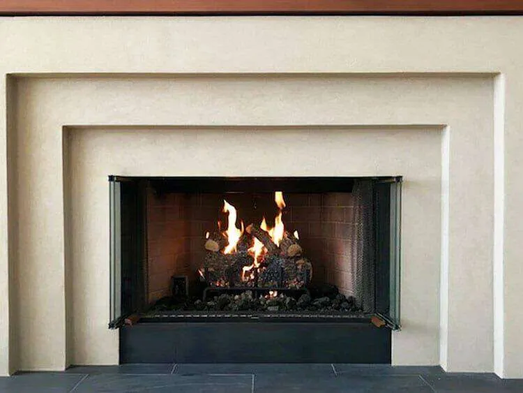 Modern fireplace with Lymestone acrylic finish and lit fire, showcasing clean lines and geometric design. — Richmond area