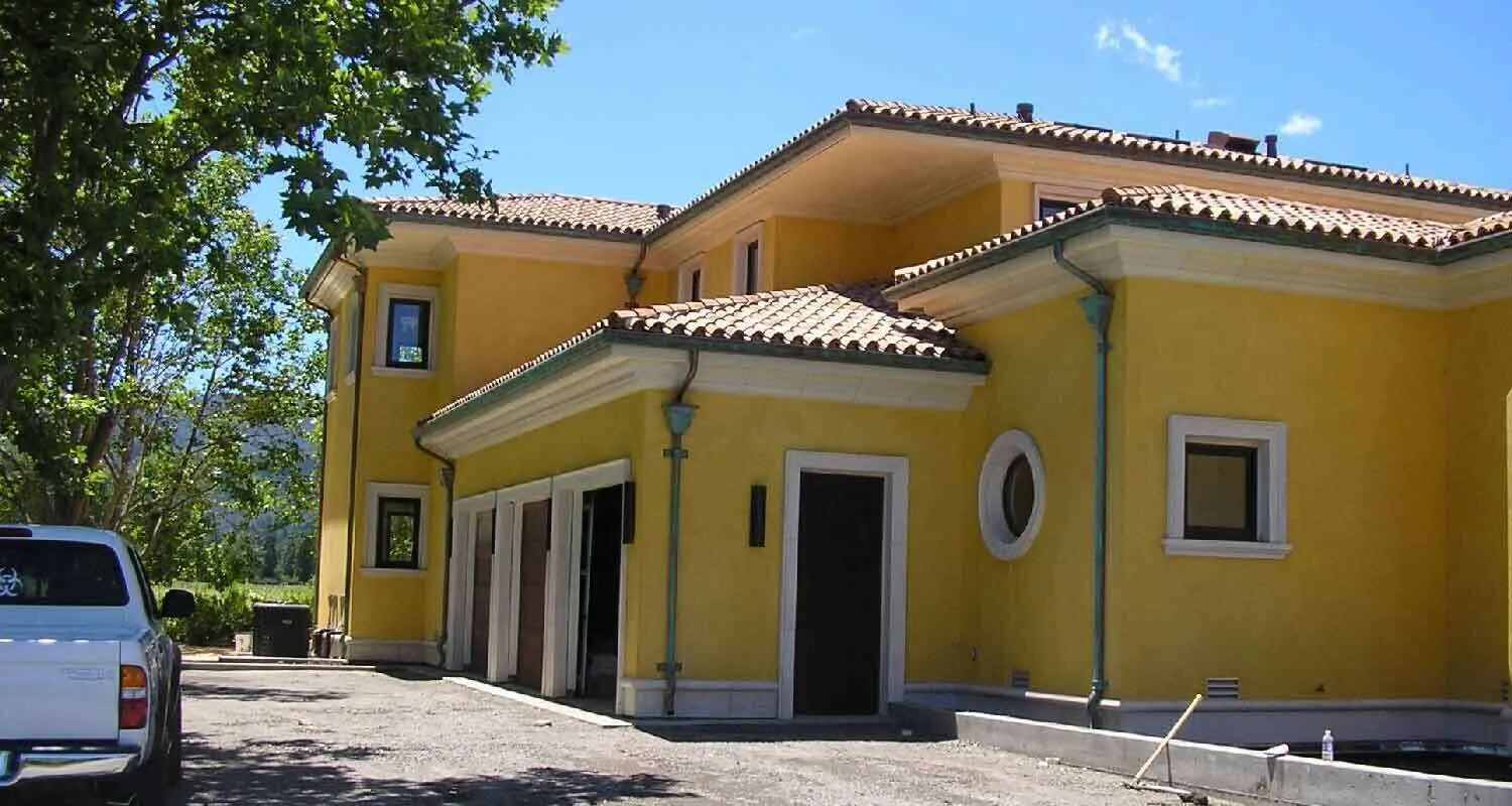 Yellow stucco Mediterranean-style home with tiled roof and driveway in Sonoma Valley. — work near Sonoma