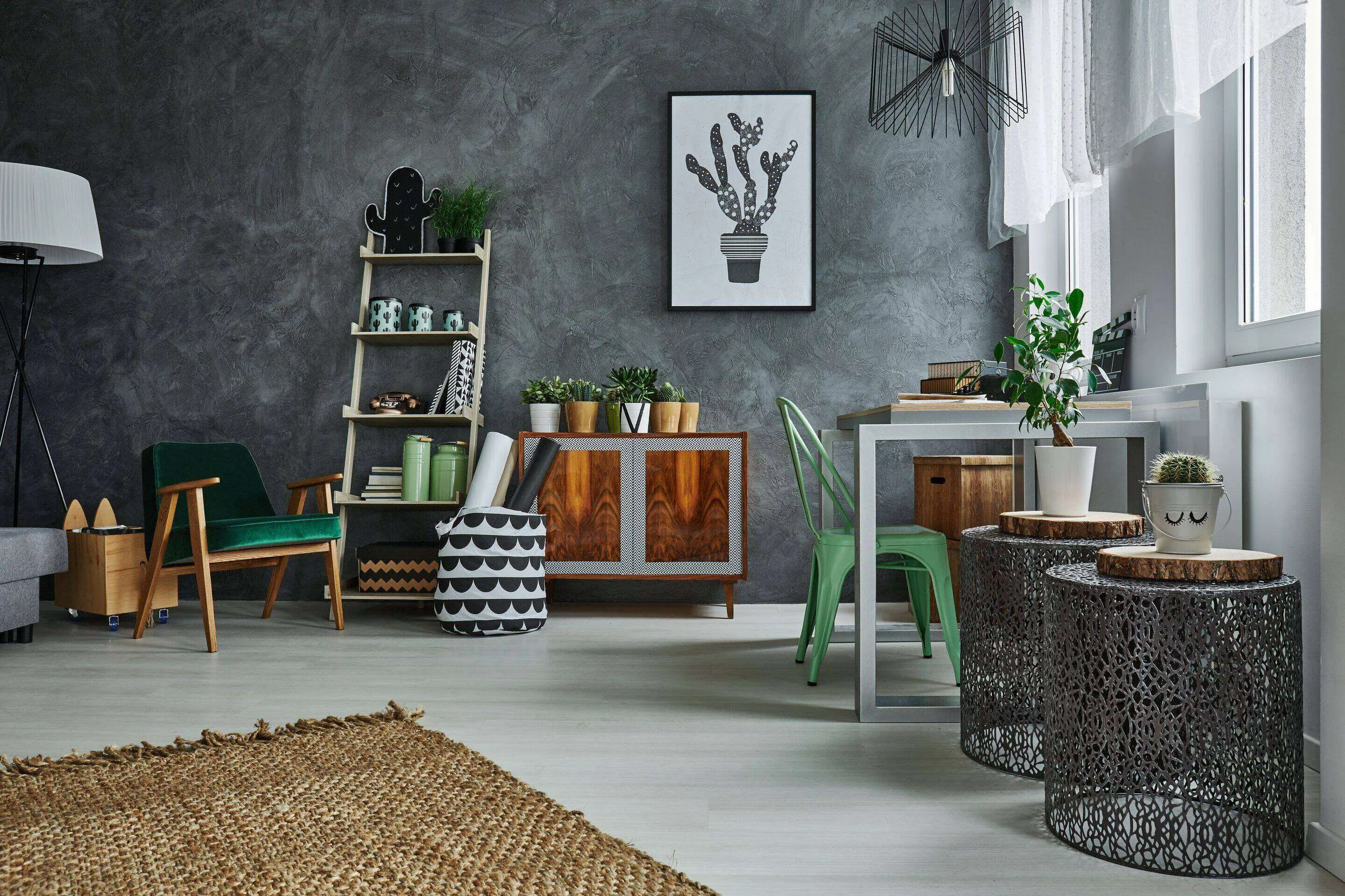 Interior room with grey stucco wall, plants, wooden cabinet, and modern furniture.
