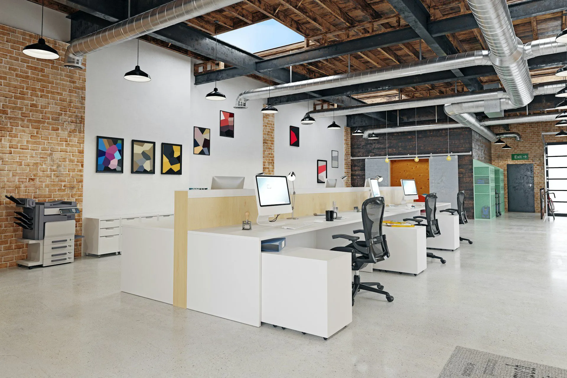 Open-plan office with exposed brick walls, industrial ductwork, and modern workstations.