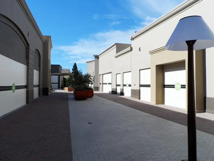 Commercial exterior with EIFS walls at Napa Town Center, featuring brick paving and planters.