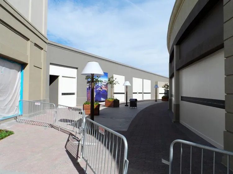 Commercial exterior with EIFS walls, curved walkway, planters, and lamp posts at Napa Town Center.