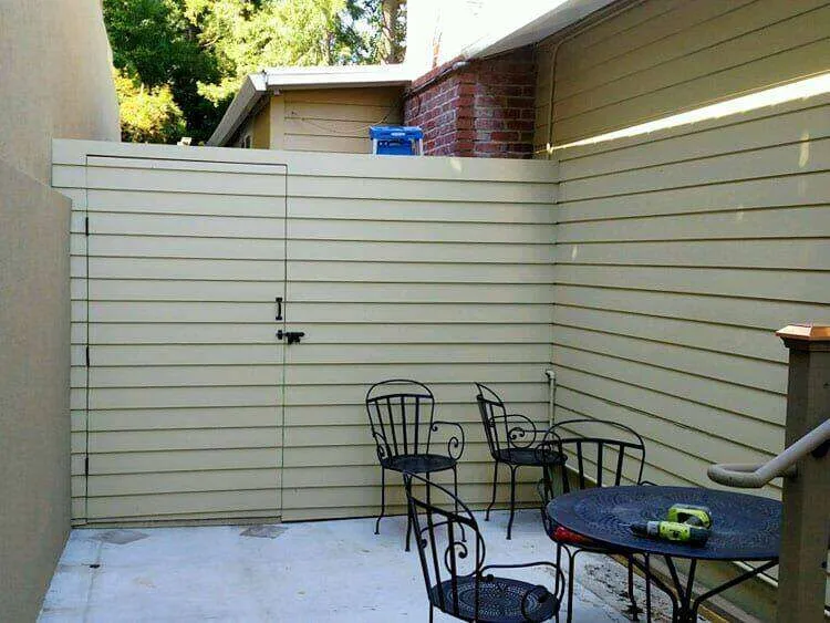 Outdoor patio with concrete floor, metal furniture, and wooden fence in Mill Valley. — Mill Valley area
