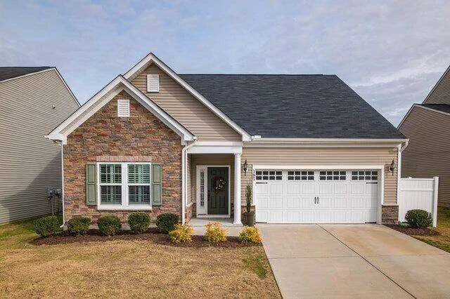 Single-family home with brick and siding exterior, gabled roof, and two-car garage.