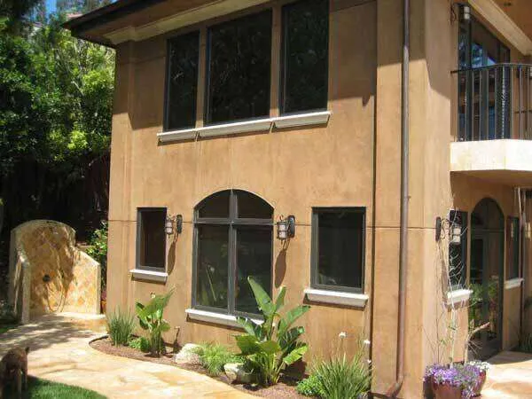 Two-story house with smooth plaster finish, large windows, and landscaped garden. — Sausalito area