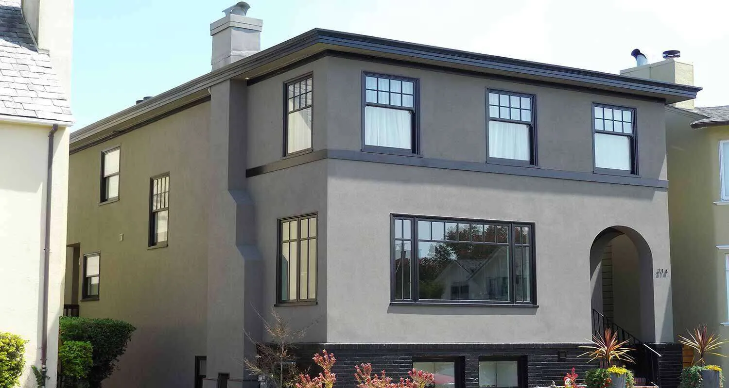 Two-story house with smooth stucco finish and black window frames. — Kentfield area