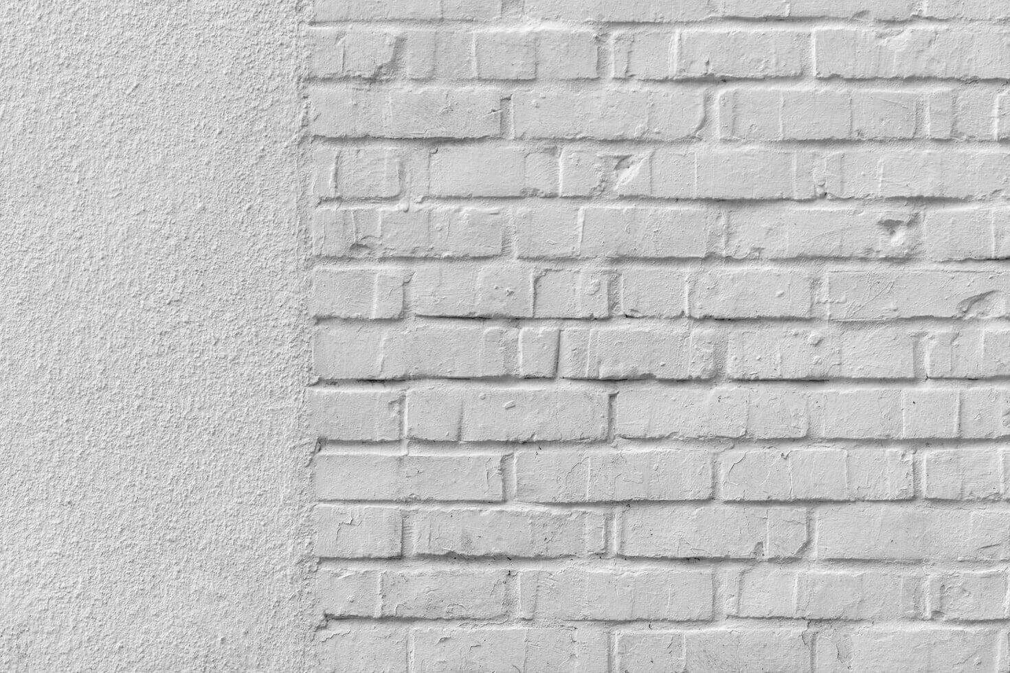 Close-up of a stucco wall with textured finish and brick pattern. — work near Alameda