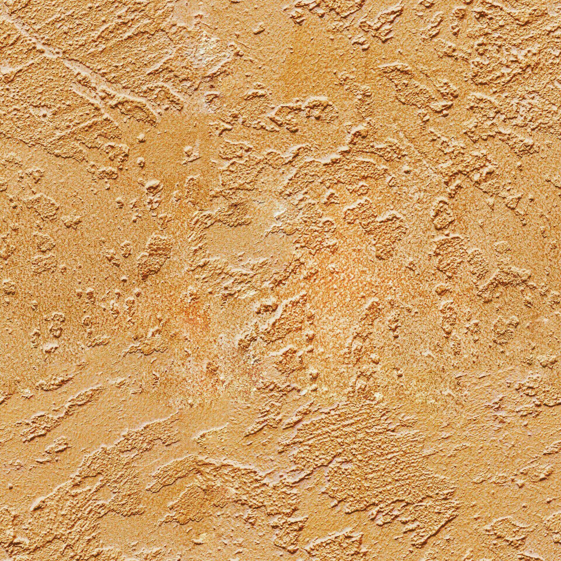 Close-up of a textured stucco wall with a rough, uneven surface in a warm, earthy tone.