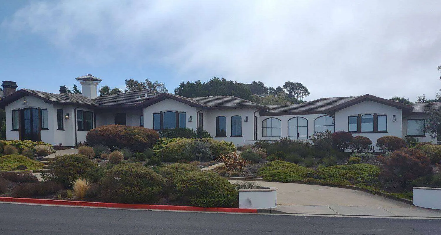 Large single-story house with white EIFS exterior and dark-framed windows in Tiburon. — work near Tiburon