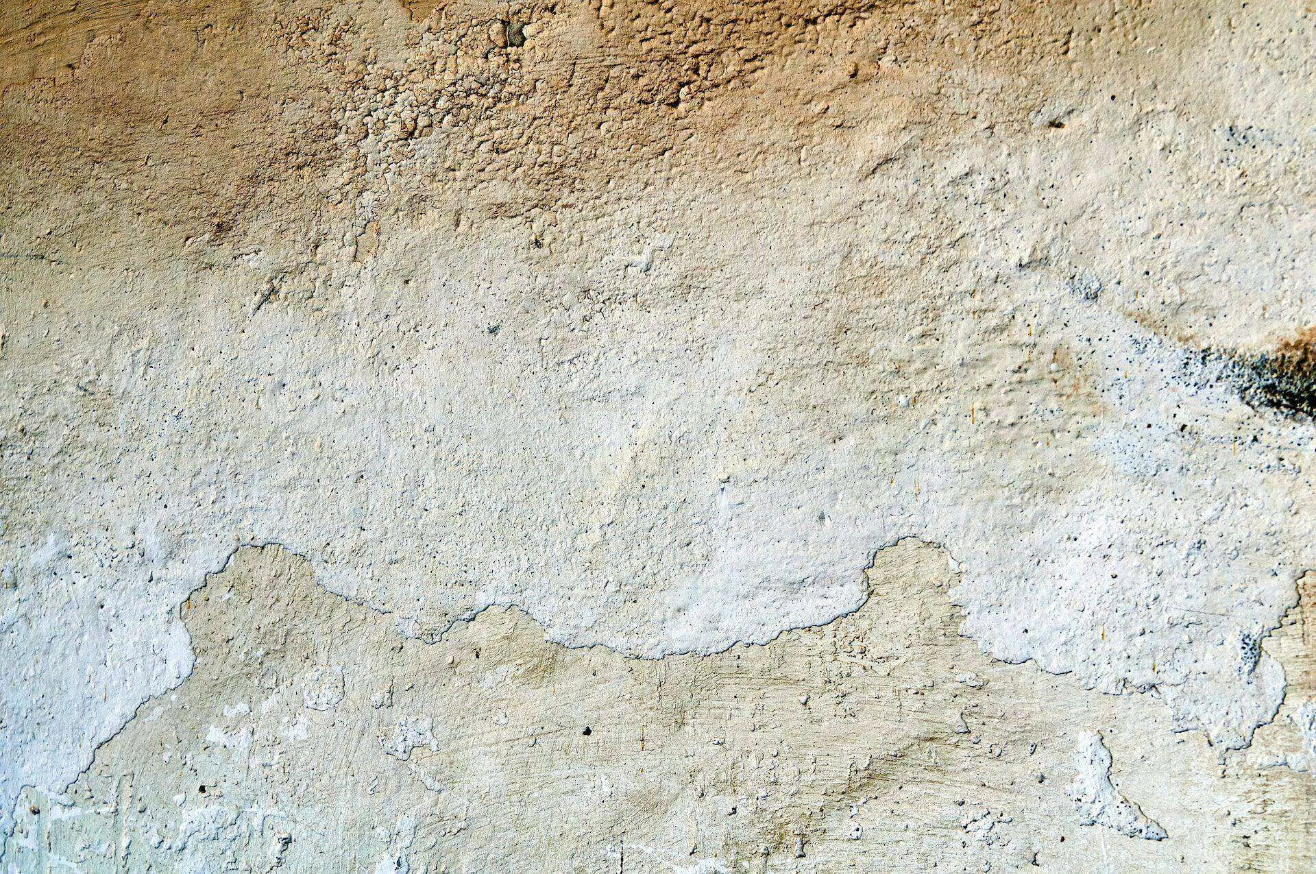 Close-up of a textured stucco wall with visible cracks and weathering. — Berkeley area